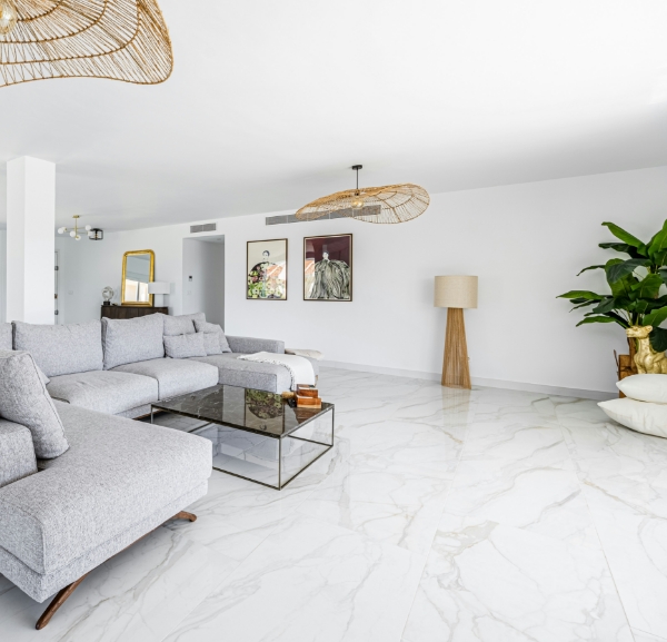 Polished marble tile flooring in modern living room remodel