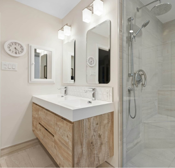 Elegant bathroom with a wooden vanity and glass shower, highlighting full bathroom upgrade services in destin